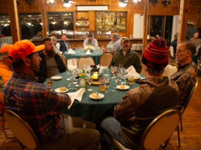 attendees seated at round dinner table