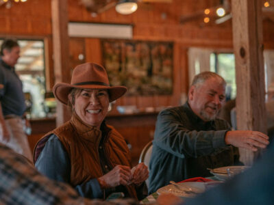 attendees indoors at the cabin of the 2023 Sage School Clay Shoot